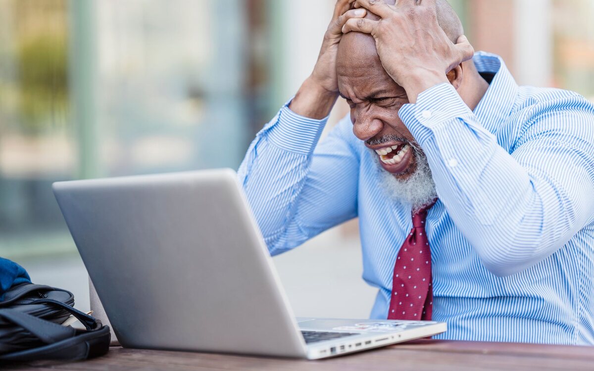Worried man in front of a laptop in an office
