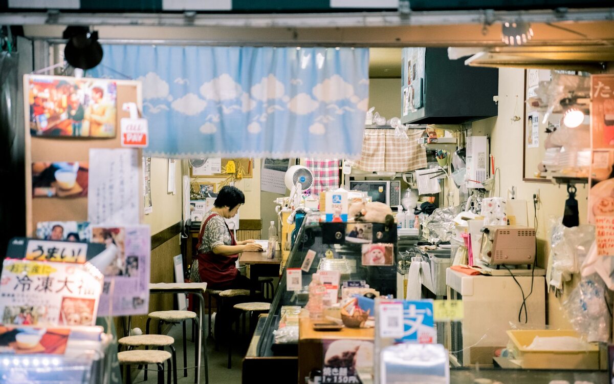 Shopkeeper behind the counter of their store