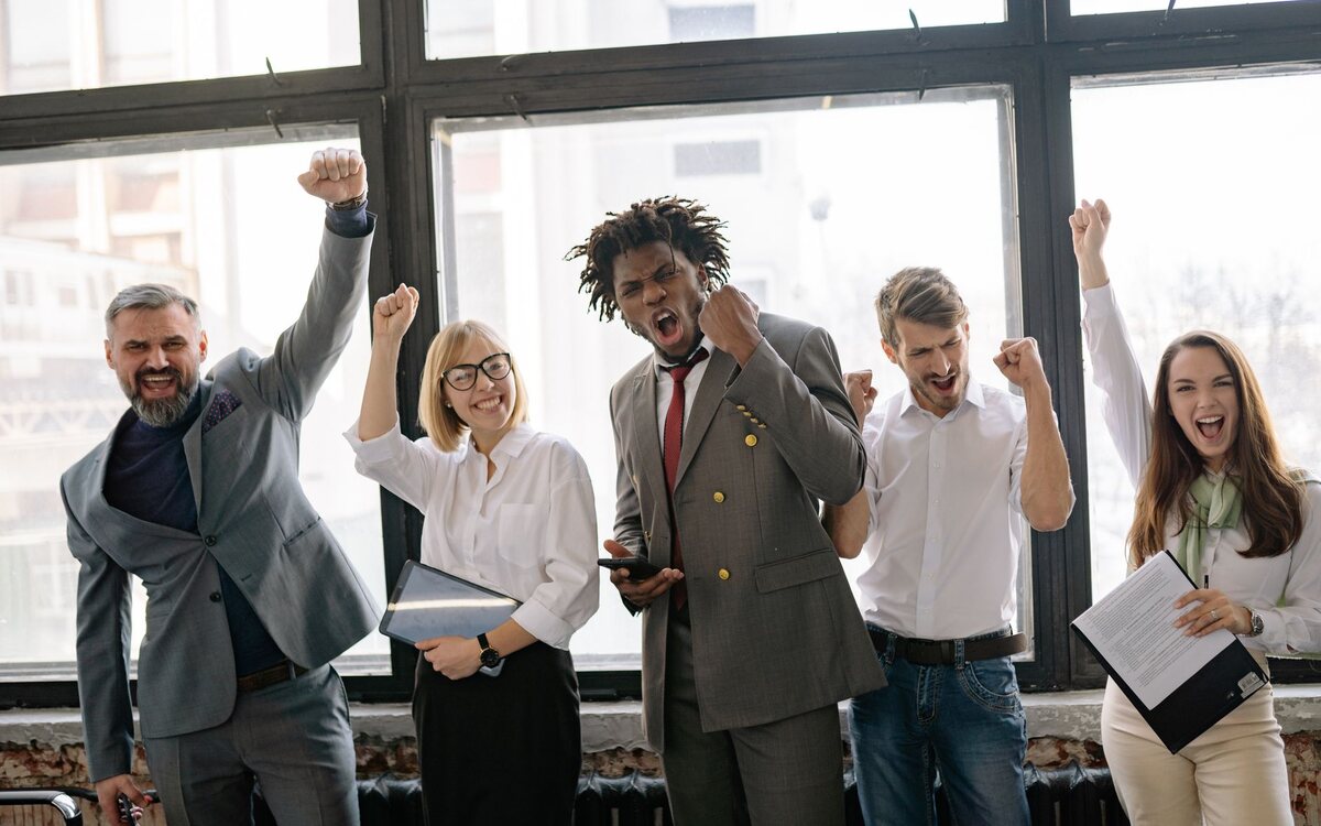 Team celebrating a result in the office