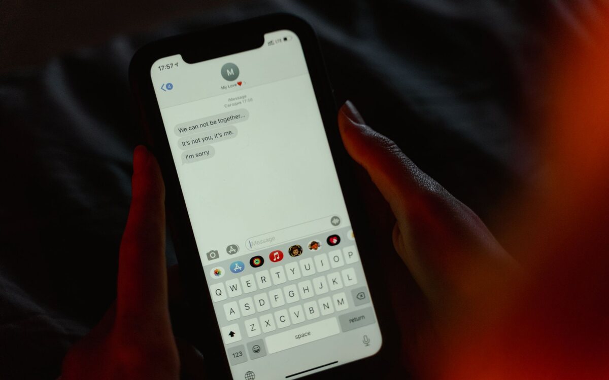 Hands typing a message on a phone screen
