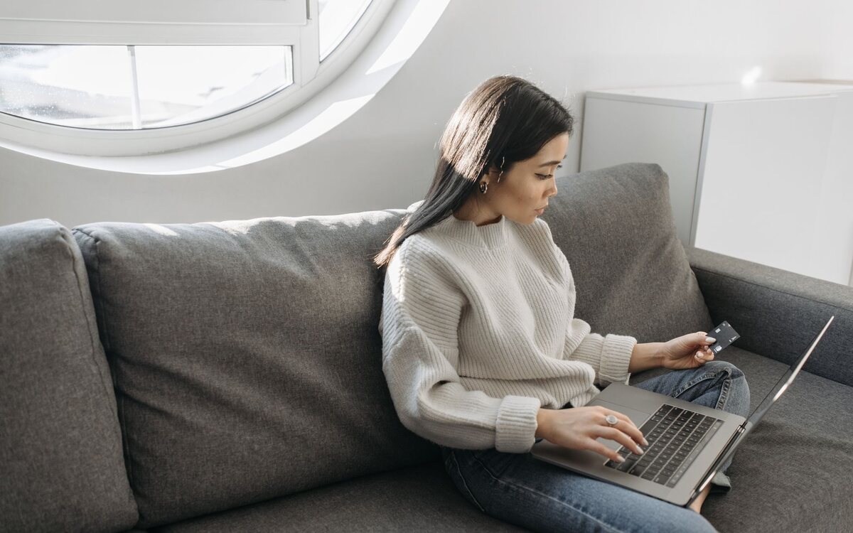 Woman shopping online on the sofa at home