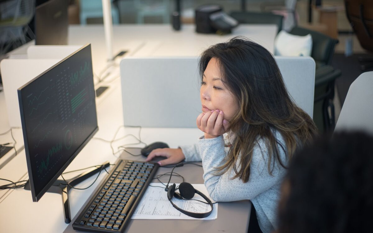 Woman working at monitors in an office